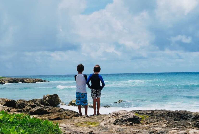 Two children looking out over the beach.